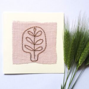 Postcard with abstract floral hand embroidery on pink linen