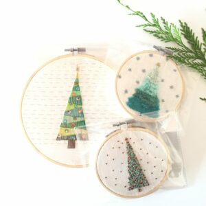 3 Christmas hoops, hand embroidery on white fabric