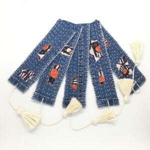 Textile bookmarks with hand embroidered details and visible mending, with tassel