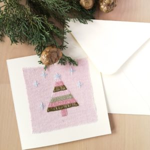 Greeting card with hand embroidered Christmas tree on pink linen