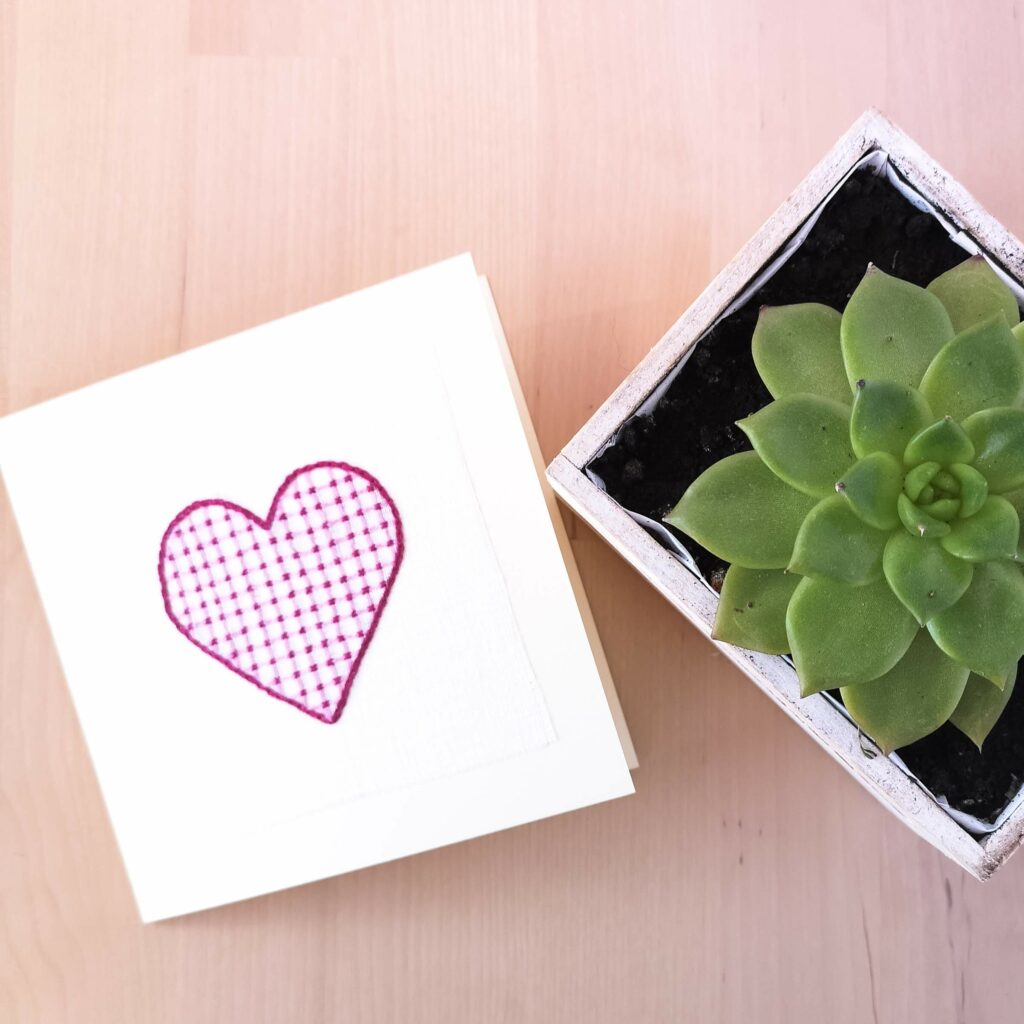 Greeting card with pink embroidered heart