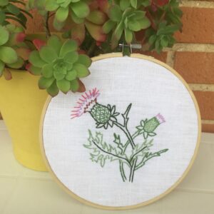 Thistle flower hand embroidery in a hoop wall hanging