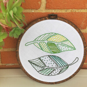 Hand embroidered hoop with green leaves