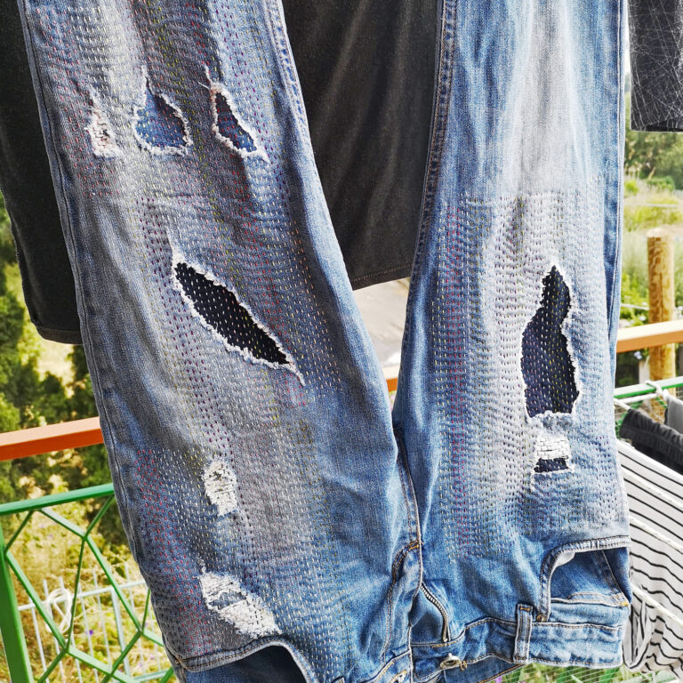 Hand embroidered jeans hanging to dry