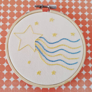 hand embroidered star with a wavy tail