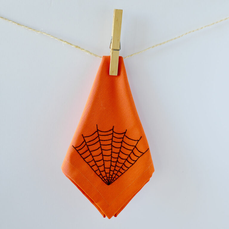 Halloween cobweb design embroidered on a fabric napkin