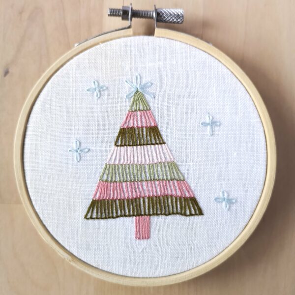 Hoop art with a small Christmas tree and snowflakes